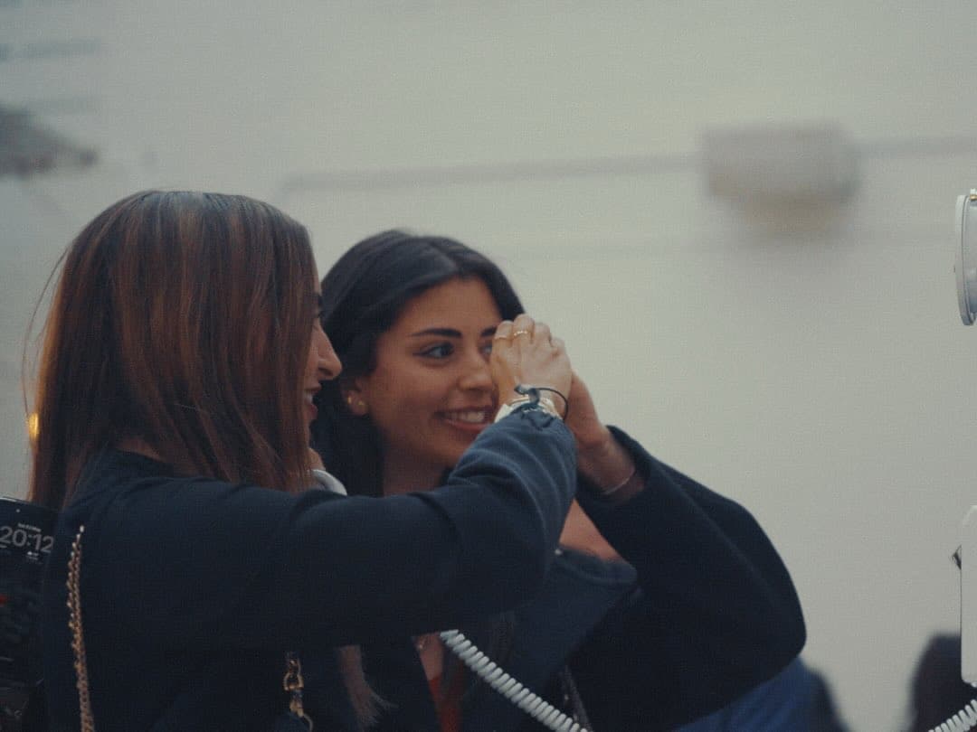 Two guests laughing together at Lights Out, an Inner Circle event