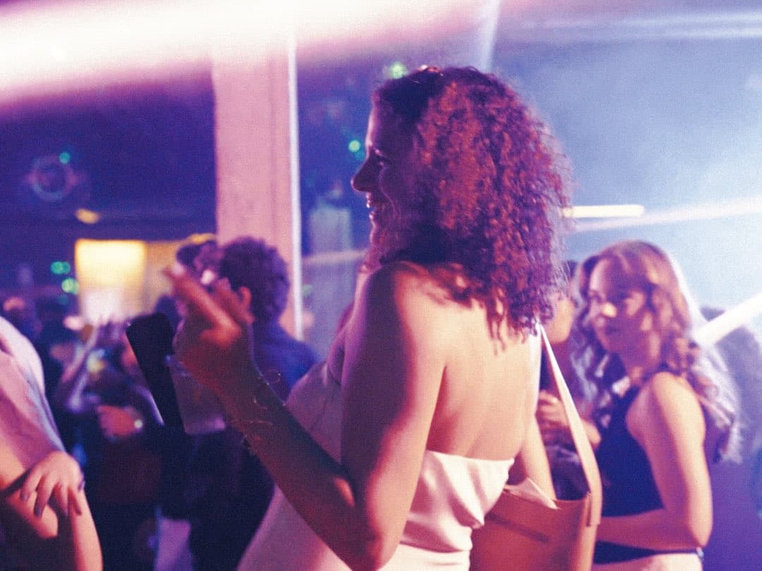 Guests dancing under coloured light on the Lights Out floor