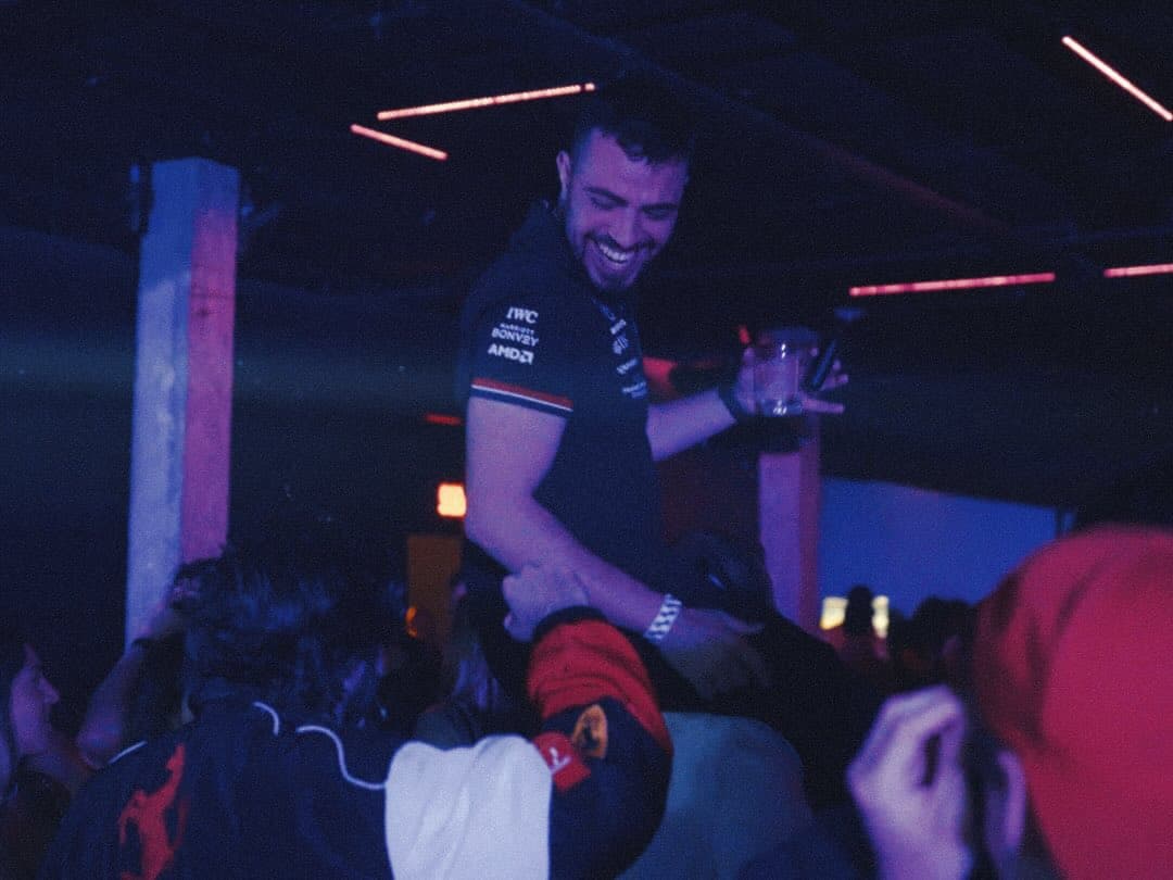 A guest in a Formula 1 team shirt lifted above the crowd at Lights Out
