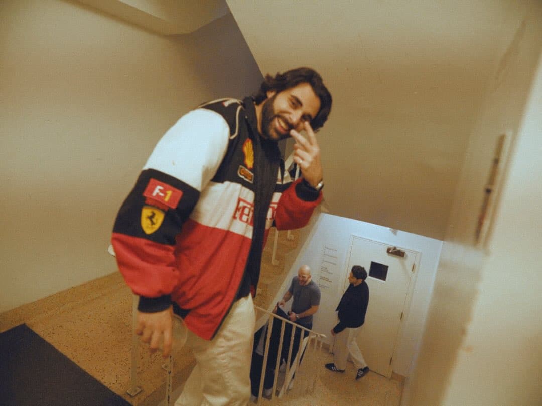 A guest in a Formula 1 team jacket at Lights Out, dressed to the night's theme